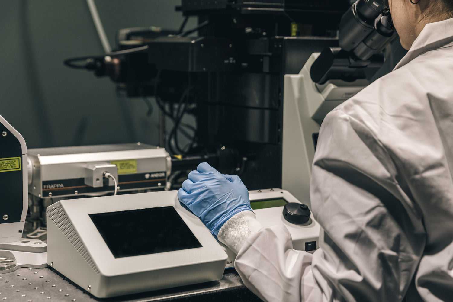 Advanced Laboratory Research with High-Resolution Microscopy – Person Analyzing Samples Using a State-of-the-Art Microscope – Enhance Scientific Discoveries with Premium Camera Lenses, Sensors, and Robotics Hardware from Camerafy – Precision Solutions for medicinal advances and Life Sciences